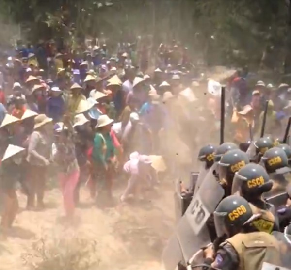 Residents throw dirt at police officers as they oppose a local wind power project in Binh Dinh Province, south-central Vietnam on April 18, 2018 in this still photo taken from a video provided by a Tuoi Tre reader.