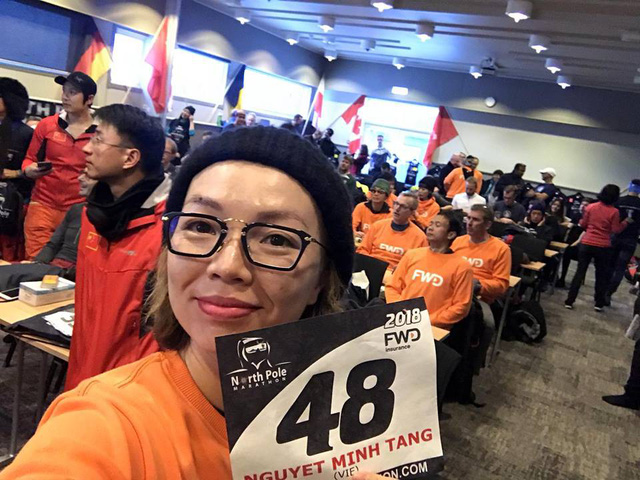 Tang Nguyet Minh proudly shows off her bib at the North Pole Marathon.