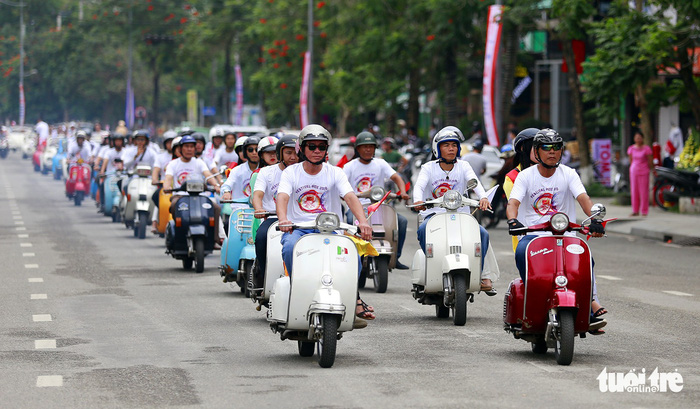 Members of the Thua Thien – Hue Vespa club lead the parade in uniform.