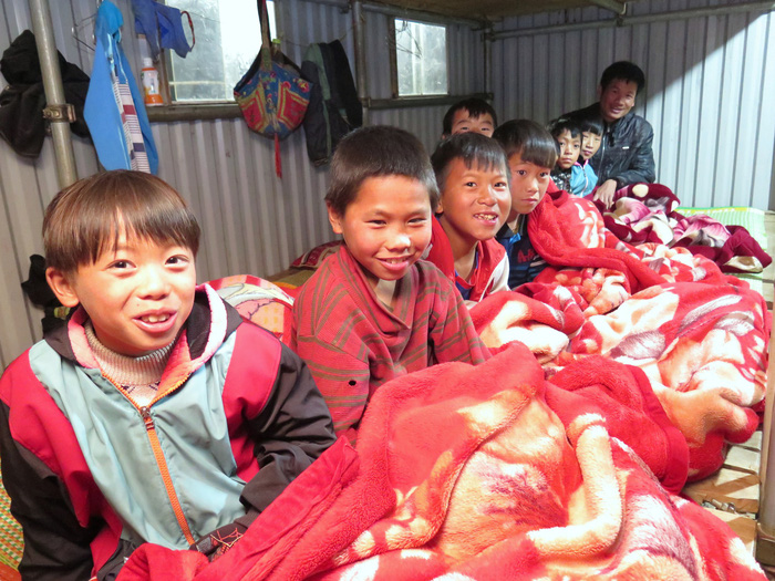 Students hide from the cold in blankets a boarding school in Son La Province, northern Vietnam. Photo: Tuoi Tre