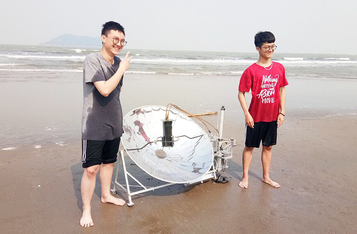 Anh (R) and Long test their machine at a local beach. Photo: Mai Nhat Anh