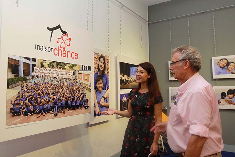 Visitors watch a photo on display at the exhibition “Daily life in Vietnam 2005 – 2017.” Photo: Vietnam News Agency