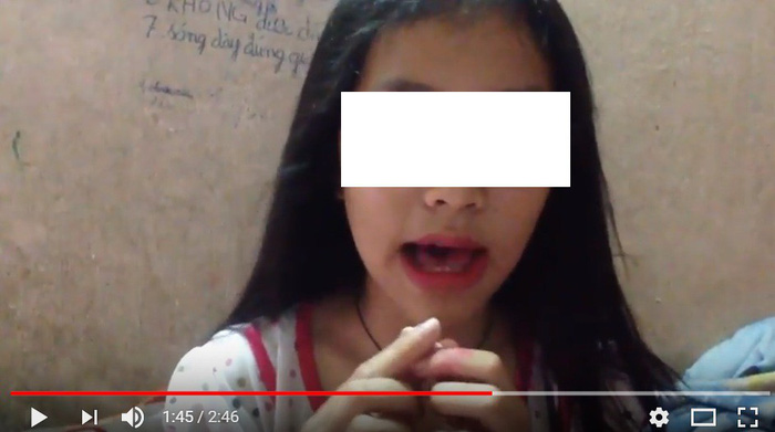 A Vietnamese girl films herself completing the Blue Whale challenge in this still photo taken from a video posted on video-sharing site YouTube.