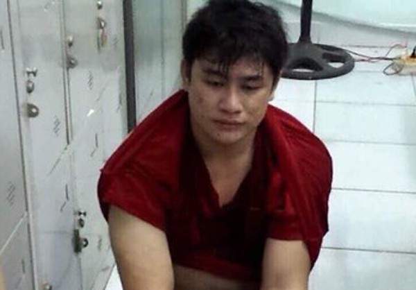 Nguyen Tan Tai is held at the police station in this photo supplied by officers.