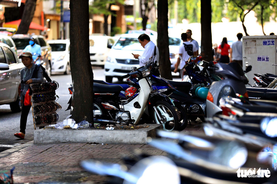 Motorcycles are parked on the pavement on Thu Khoa Huan Street in District 1, Ho Chi Minh City, Vietnam. Photo: Tuoi Tre