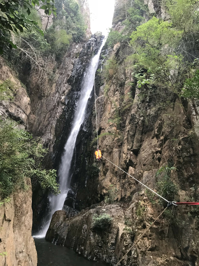 The body of A.T.K. is moved on a rope up a waterfall in Binh Thuan, south-central Vietnam, in this supplied photo.