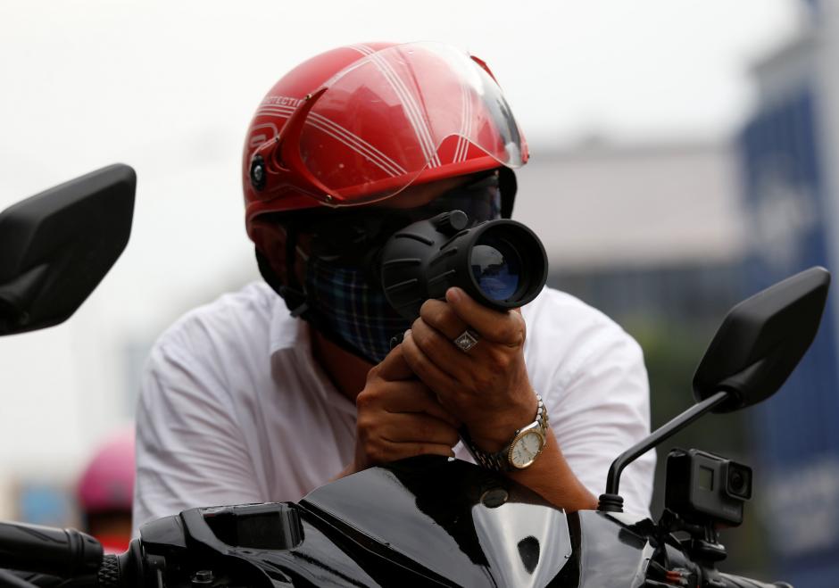 Vietnamese-American Mai Truong Xuan Huy looks through a binocular while he patrols with his