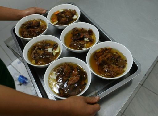 Bowls of ‘bun cha’ are carried on a tray in the restaurant which Obama and Bourdain visited in 2016 in Hanoi, Vietnam. Photo: AFP