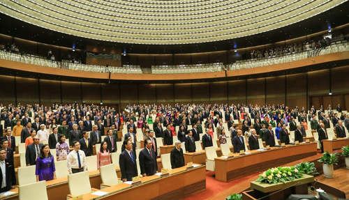 Delegates stand for the national anthem at the closing ceremony of the fifth session of Vietnam's lawmaking National Assembly in Hanoi on June 15, 2018. Photo: Vietnam News Agency