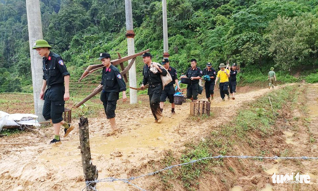 Police officers help residents in Lai Chau collect their property following the flood.