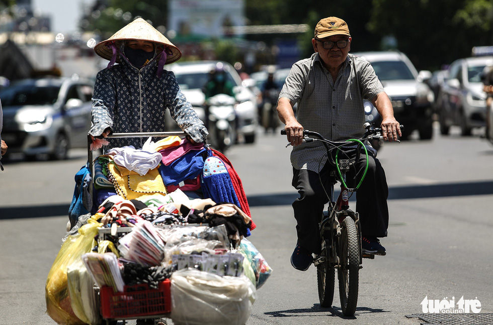 Residents travel under the extreme heat in Hanoi.