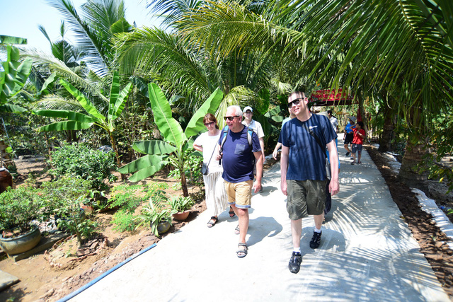 Foreign visitors are seen on a tour to Vietnam’s Mekong Delta. Photo: Tuoi Tre
