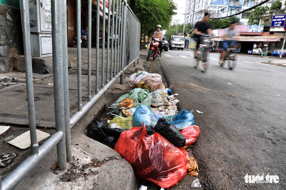 Countless bags of rubbish are dumped at a sewer on Nguyen Khoai Street in District 4.