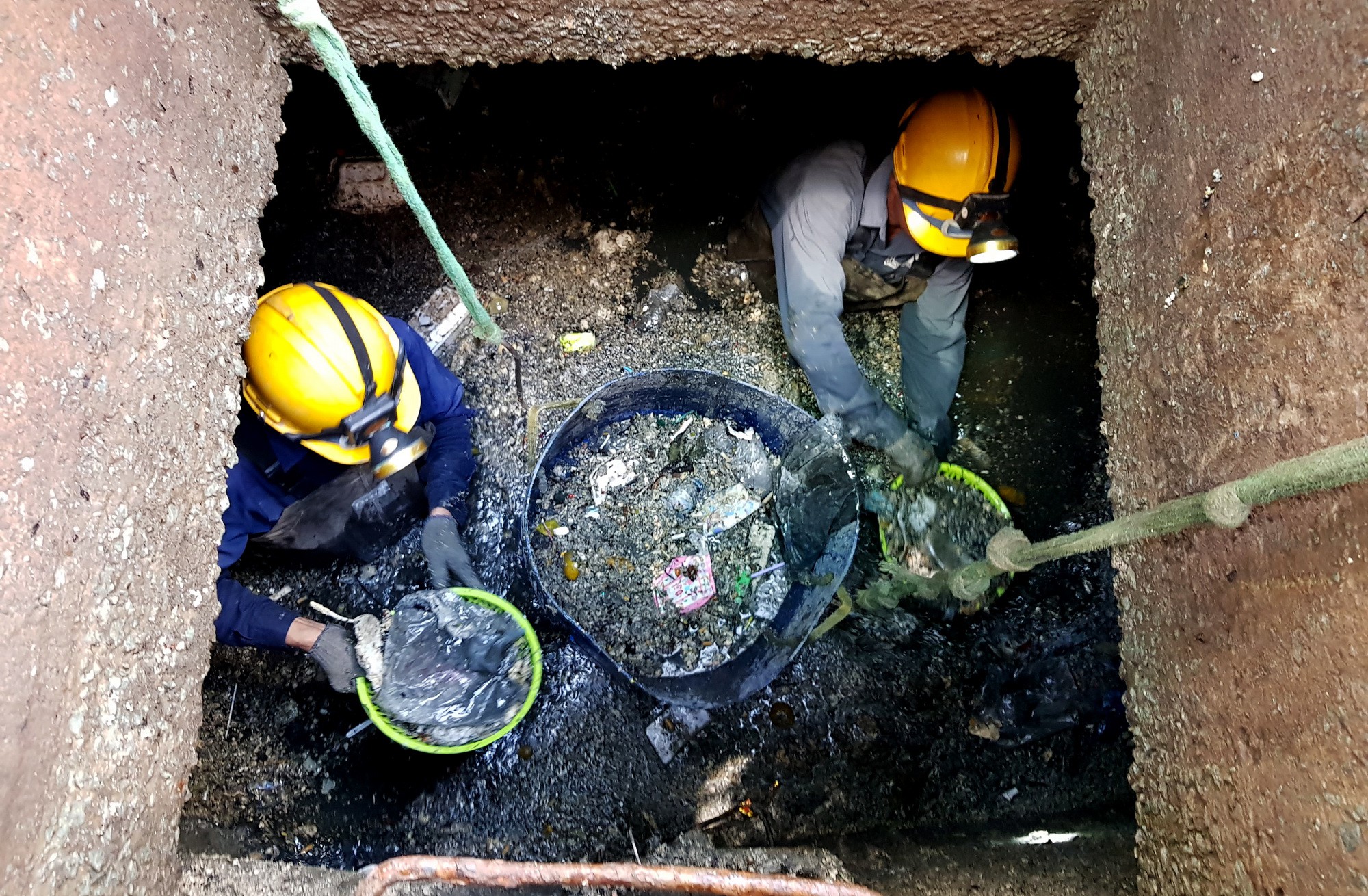 Drainage workers collect garbage in a sewage pipe in Ho Chi Minh City, Vietnam. Photo: Tuoi Tre