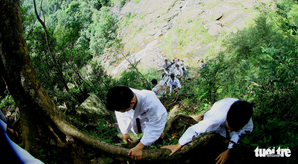 Karate students move to a higher ground in the Bach Ma (‘White Horse’) Mountain in Thua Thien-Hue Province, Vietnam. Photo: Tuoi Tre