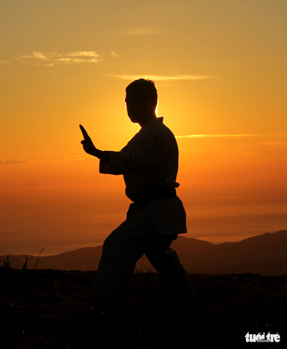 A karate practitioner is seen in silhouette in the Bach Ma (‘White Horse’) Mountain in Thua Thien-Hue Province, Vietnam. Photo: Tuoi Tre