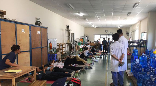 The workers are treated at the hospital on July 6. Photo: Tuoi Tre