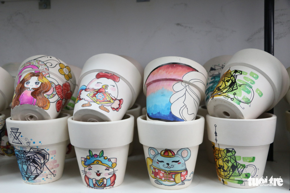 Plant pots are decorated with adorable images in the lovely “chibi” art style at Joy Garden. Photo: Tuoi Tre