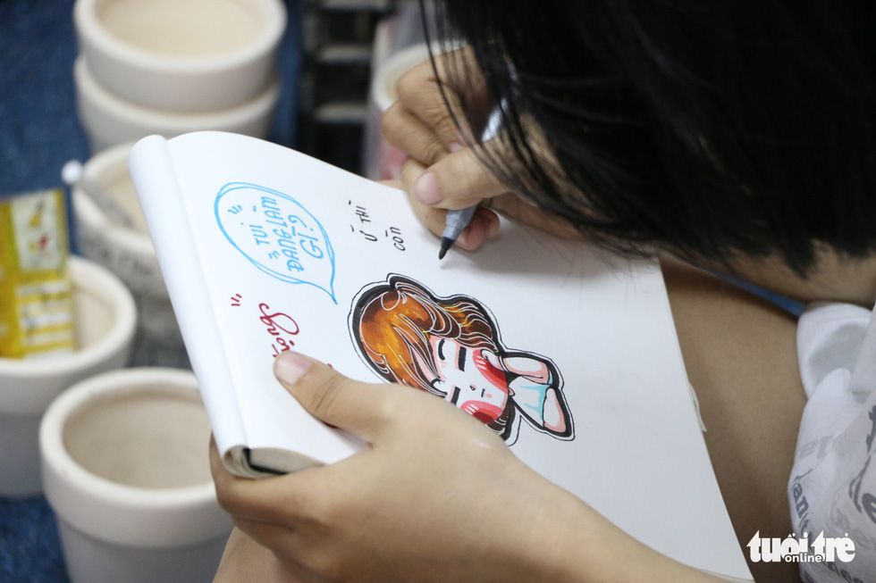 A staff draws an adorable image in the lovely “chibi” art style at Joy Garden. Photo: Tuoi Tre