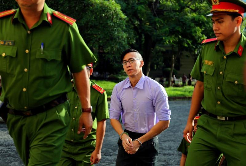 US citizen Will Nguyen (C) is escorted by policemen before his trial at a court in Ho Chi Minh city, Vietnam July 20, 2018. Photo: Reuters