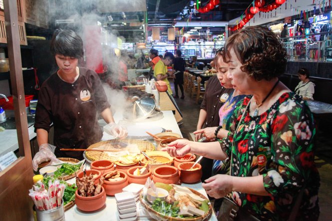 A food seller is seen at Sense Market in Ho Chi Minh City. Photo: Tuoi Tre