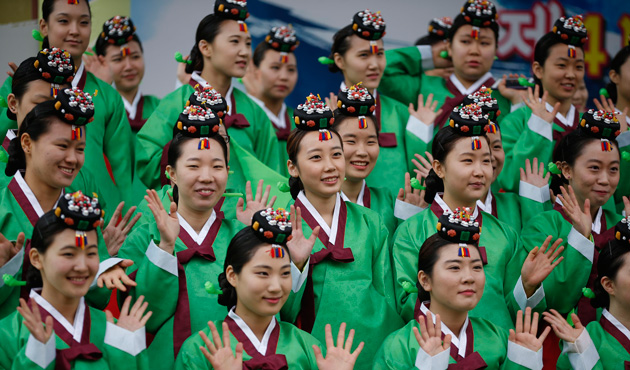 Women wearing traditional Korean Hanbok costume, pose for a group photo after a traditional coming-of-age day ceremony at Namsangol Hanok Village in Seoul May 20, 2013.