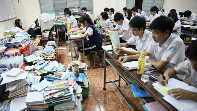 Students are pictured reviewing their lessons at night at Nguyen Khuyen High School in Tan Binh District.