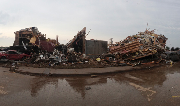 Destroyed buildings and overturned cars are seen after a huge tornado struck Moore, Oklahoma, near Oklahoma City, May 20, 2013.