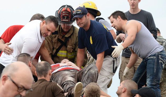 Rescue workers help free one of the 15 people that were trap at a medical building at the Moore hospital complex after a tornado tore through the area of Moore, Oklahoma May 20, 2013.