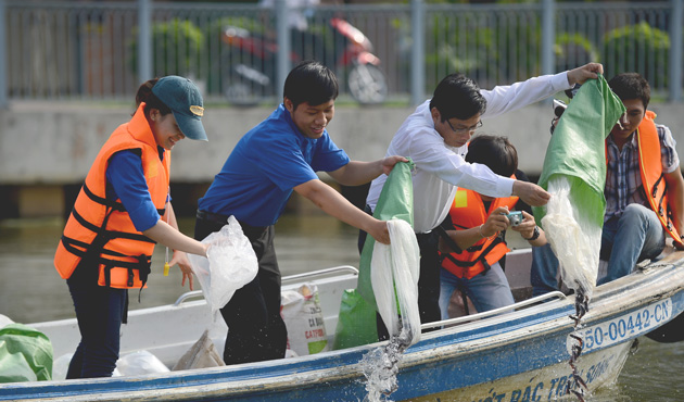 Youths and officials release fish with the hope that the water sources of the canals will be improved.