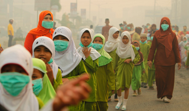 Muslim students wearing masks walk as they celebrate 