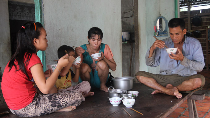 The family of farmer Ton Van Hung gets together for a frugal meal after a hard day on the field.