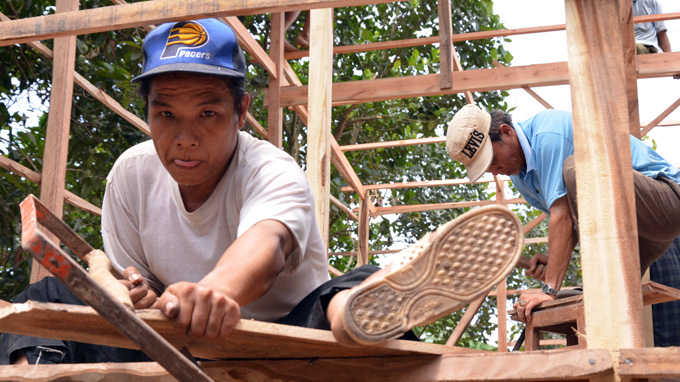 Ut Mong, another farmer, quit his job as a bicycle repairer to spend time building a new house for Tran Thi Chau, a poor woman in Tan Quoi commune.