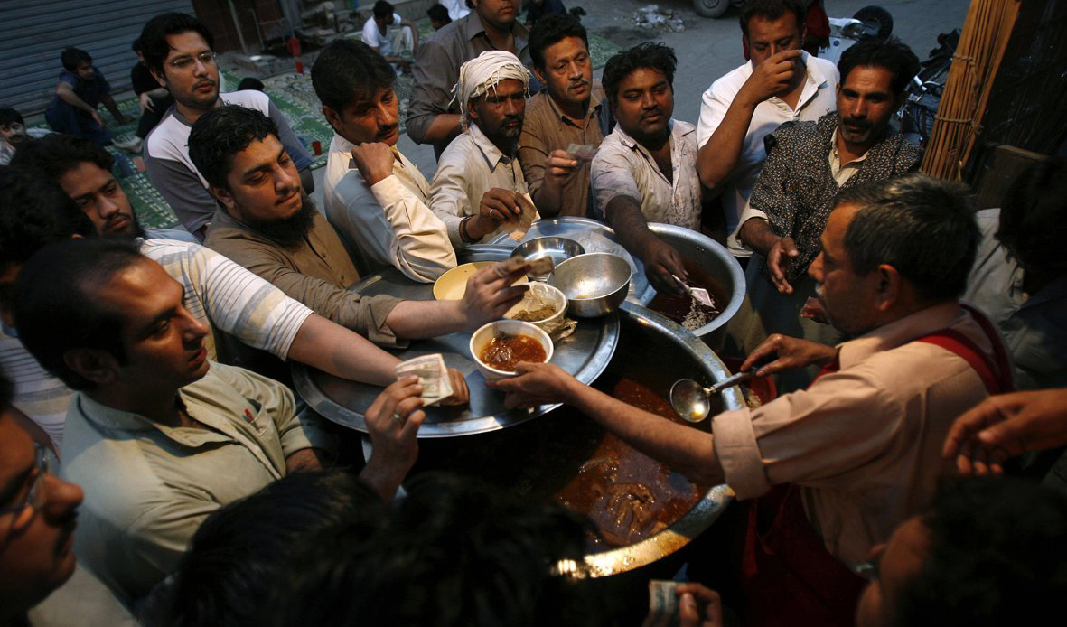 In Lahore, Pakistan, men line up for Siri Paya, a traditional breakfast dish made of goat heads and feet.