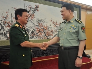 Vietnam, China pledge to boost defense ties