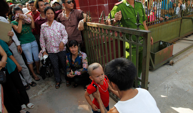 A former inmate (L) is greeted by his relative after he is released from Hoang Tien prison, about 100 km (62 miles) outside Hanoi August 30, 2013.