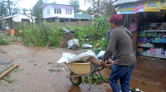 A resident uses a wheelbarrow to recover the body of a victim after Typhoon Haiyan hit the municipality of Coron, Palawan province in central Philippines November 9, 2013.