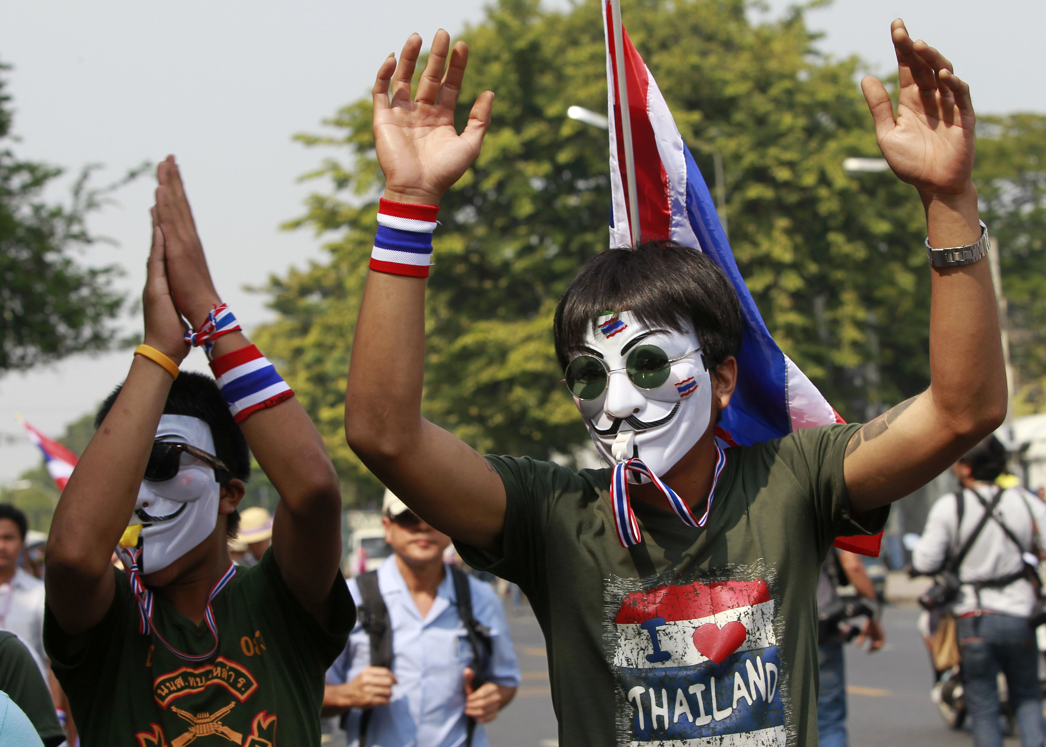 Thai PM calls elections as 100,000 join protests