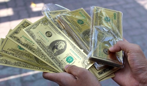 Gold US dollar bills for sale on Saigon streets