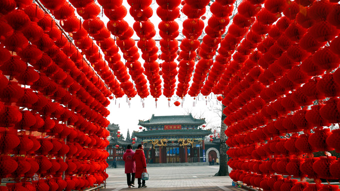 Visitors walk past red lantern decorations at Longtan park ahead of the upcoming Chinese lunar New Year in Beijing January 29, 2014.