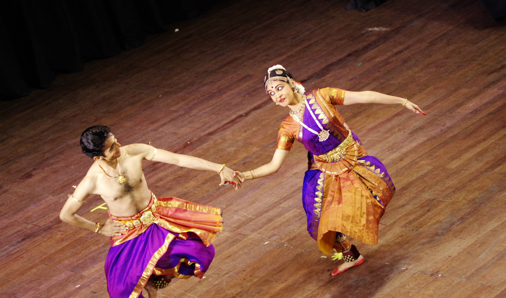 Indian male and female dancers perform the Bharatanatyam dance.