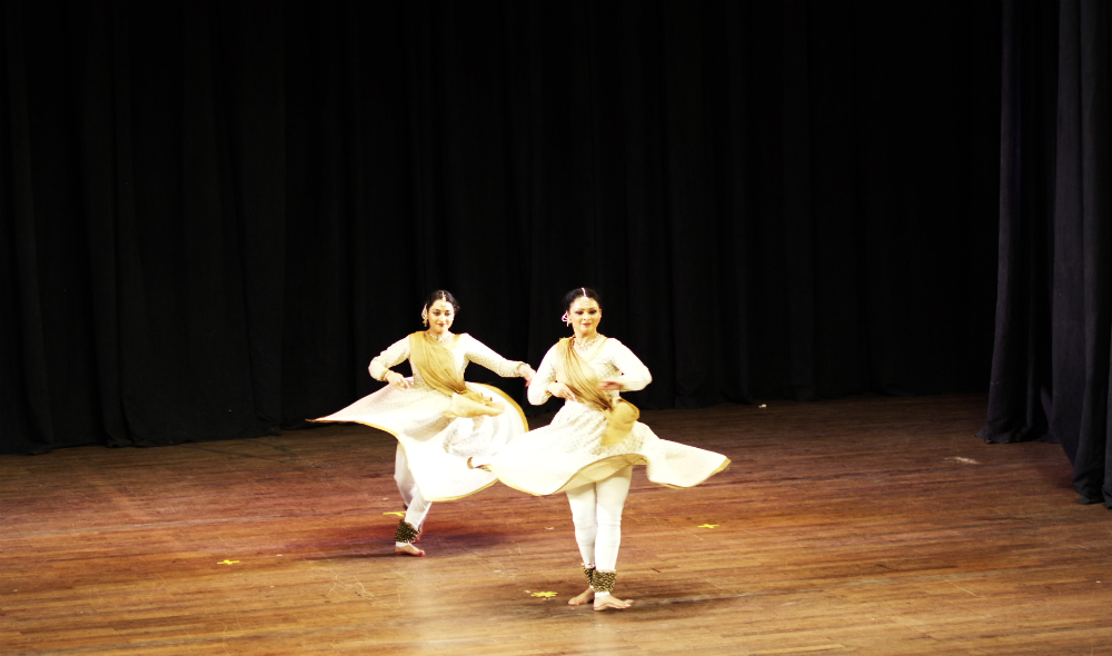 Two Indian female artists show off their skills in a Kathak dance.