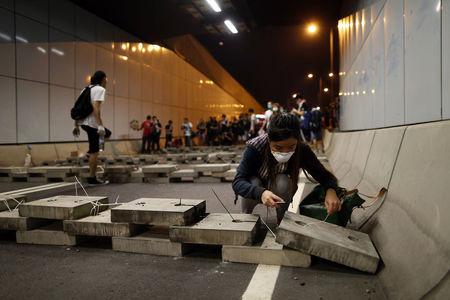 Hong Kong tycoon calls for protests to end after tension over police beating