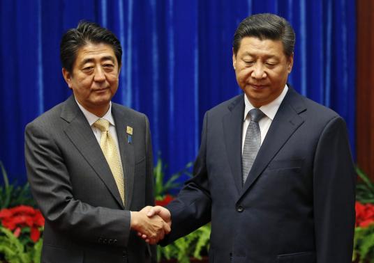 China's Xi, Japan's Abe hold landmark meeting after awkward handshake