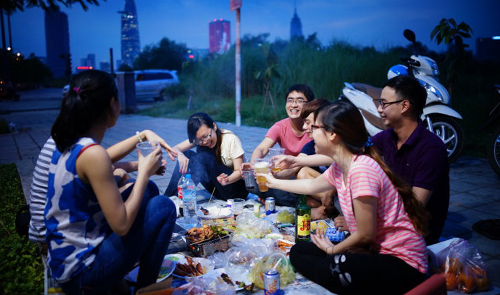 Picnicking at night on new boulevard in Ho Chi Minh City