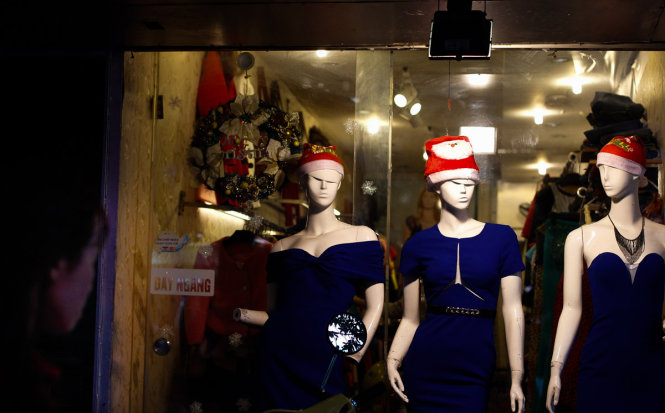 Mannequins wear Santa Claus hats, standing on Hang Bong Street in Hanoi.