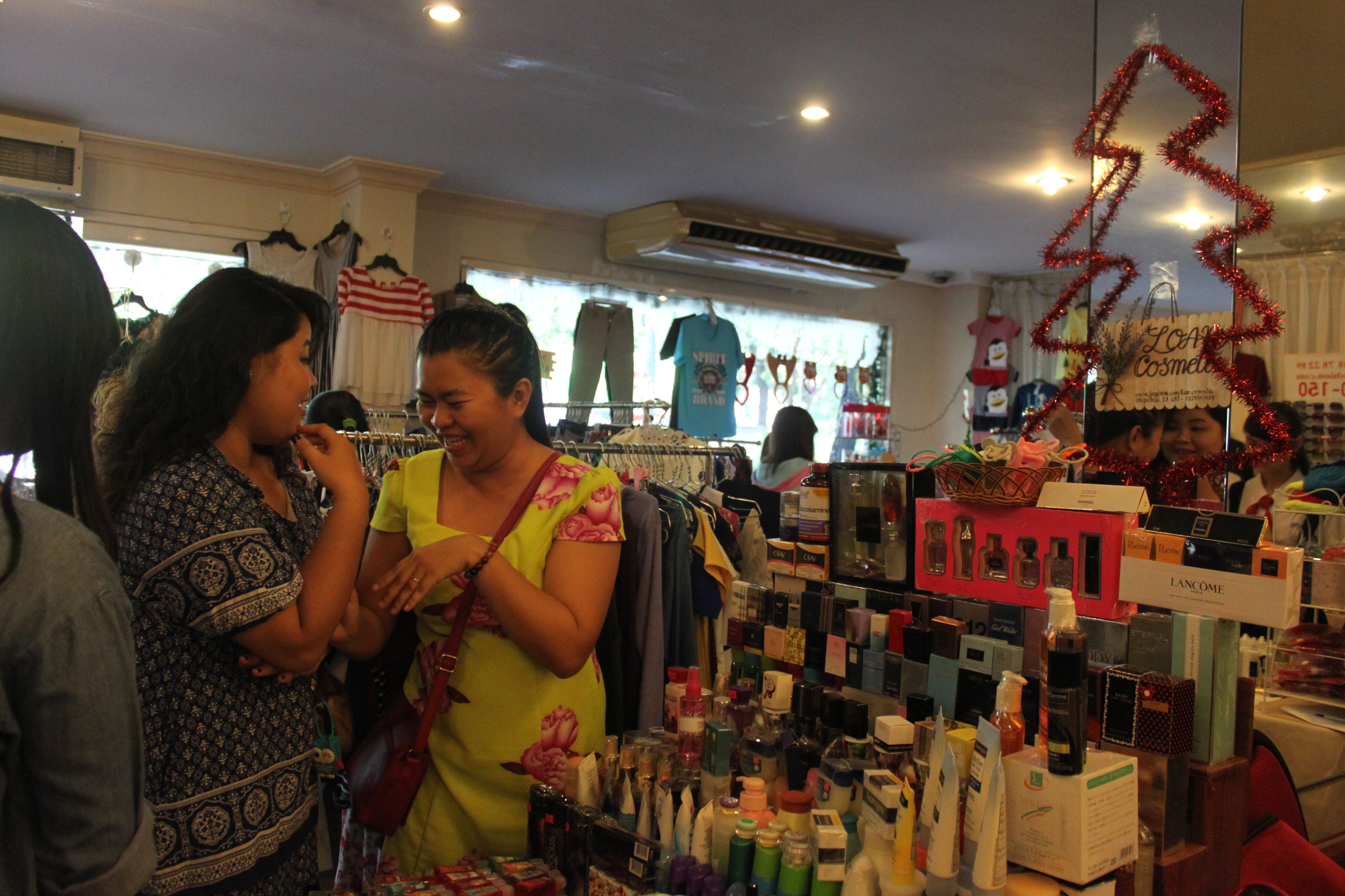 Two customers talking to each other at a cosmetic booth at the 1Spot flea market in District 1, Ho Chi Minh City, on December 20, 2014.