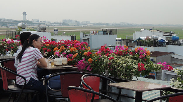 Terraced cafés near Ho Chi Minh City airport offer close-up views of airplanes
