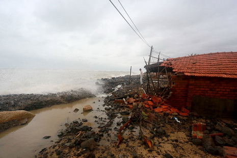 A local household’s tiled roof is shown being demolished by tidal waves.