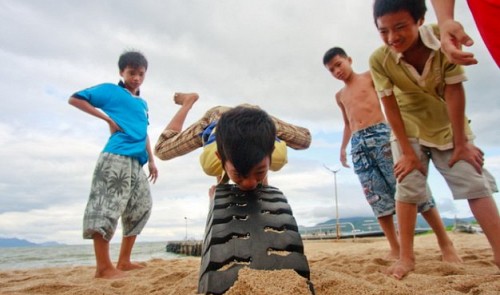 Parkouring with a used tire in Nha Trang City, the capital of the south-central province of Khanh Hoa